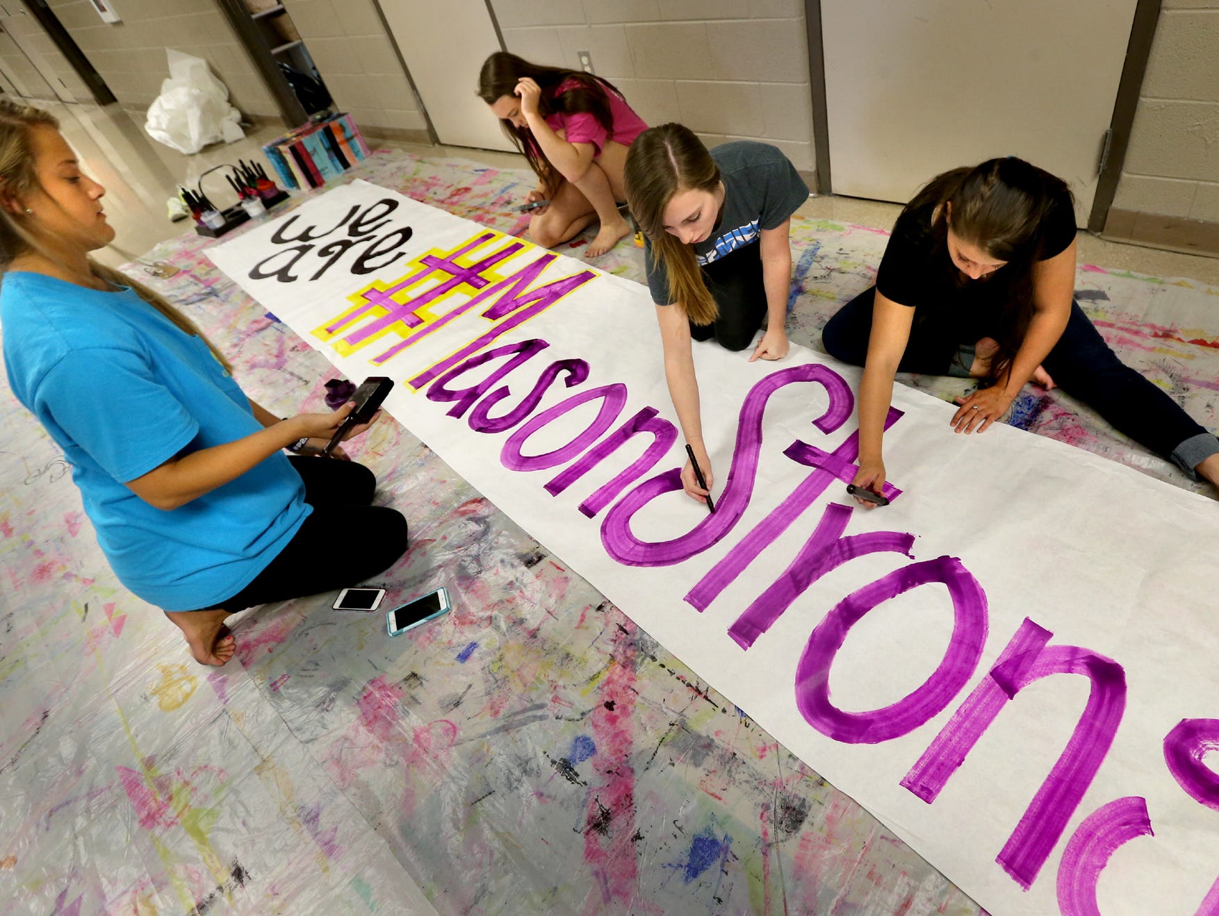 Siegel Cheerleaders, from left, Lexi Davis, a senior; Delaina McDonald, a junior; Sydney Myers, a sophomore; and Sylvia Waldon, a junior; make a sign Thursday to be displayed at Friday night's game against Oakland. The sign is in memory of Mason Loupe, a Siegel football player who died Wednesday.
