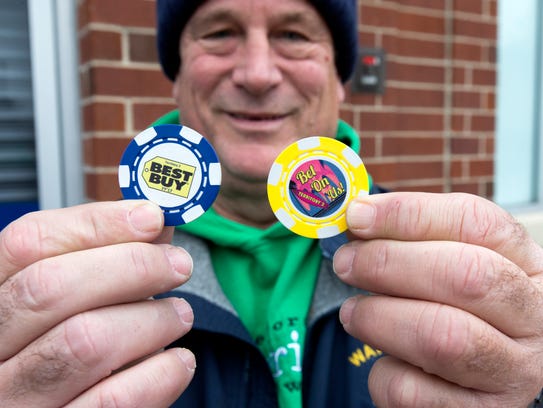 Mike Franke holds a pair of commemorative chips he