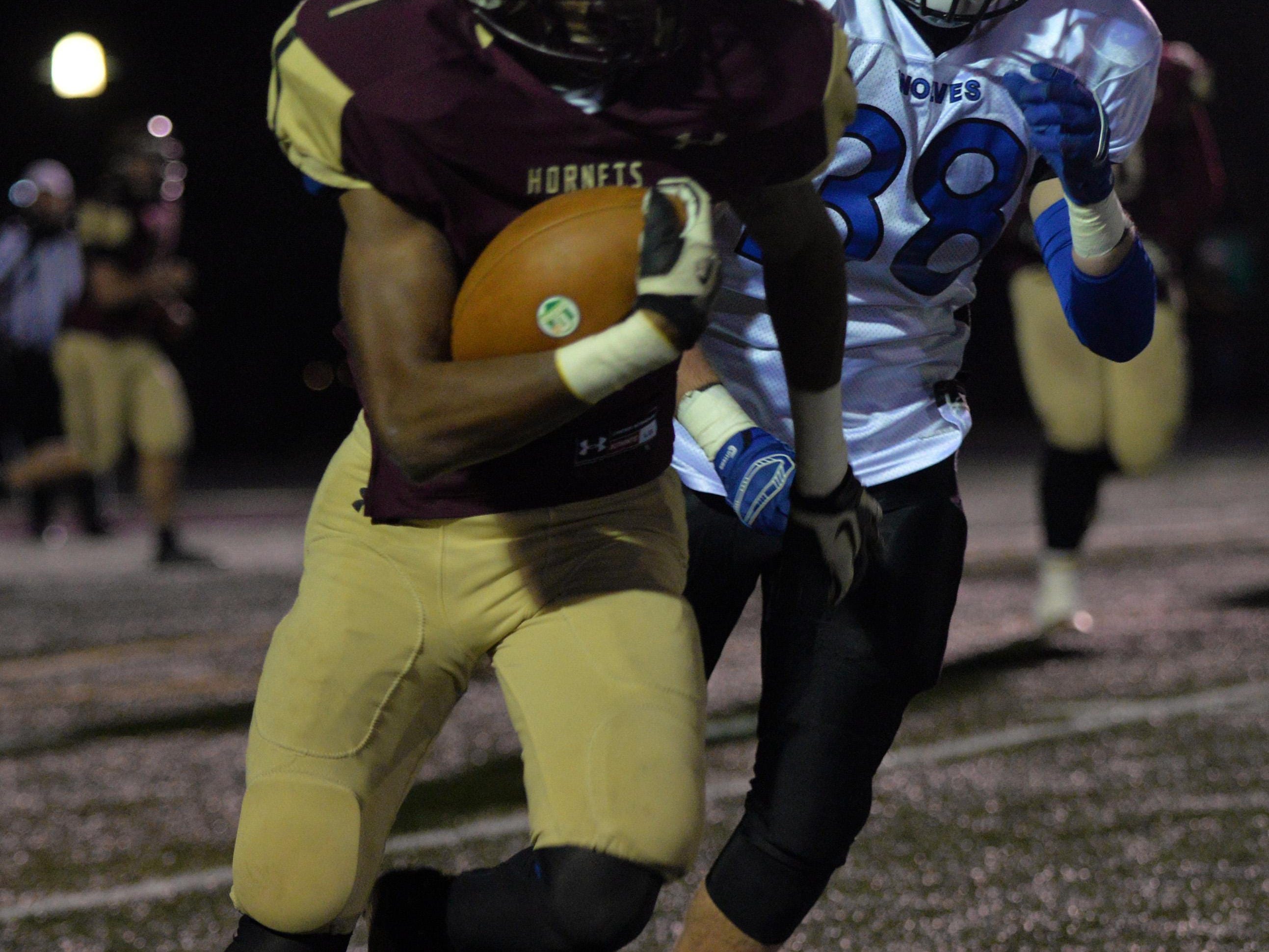 Licking Heights senior London Pearson runs away from a Worthington Kilbourne defender during a Division II playoff game Nov. 13. Pearson was named to the All-Ohio first team on Monday.