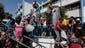 Displaced Palestinians wait to collect water at a United Nations school where their families are taking refuge in Gaza City.