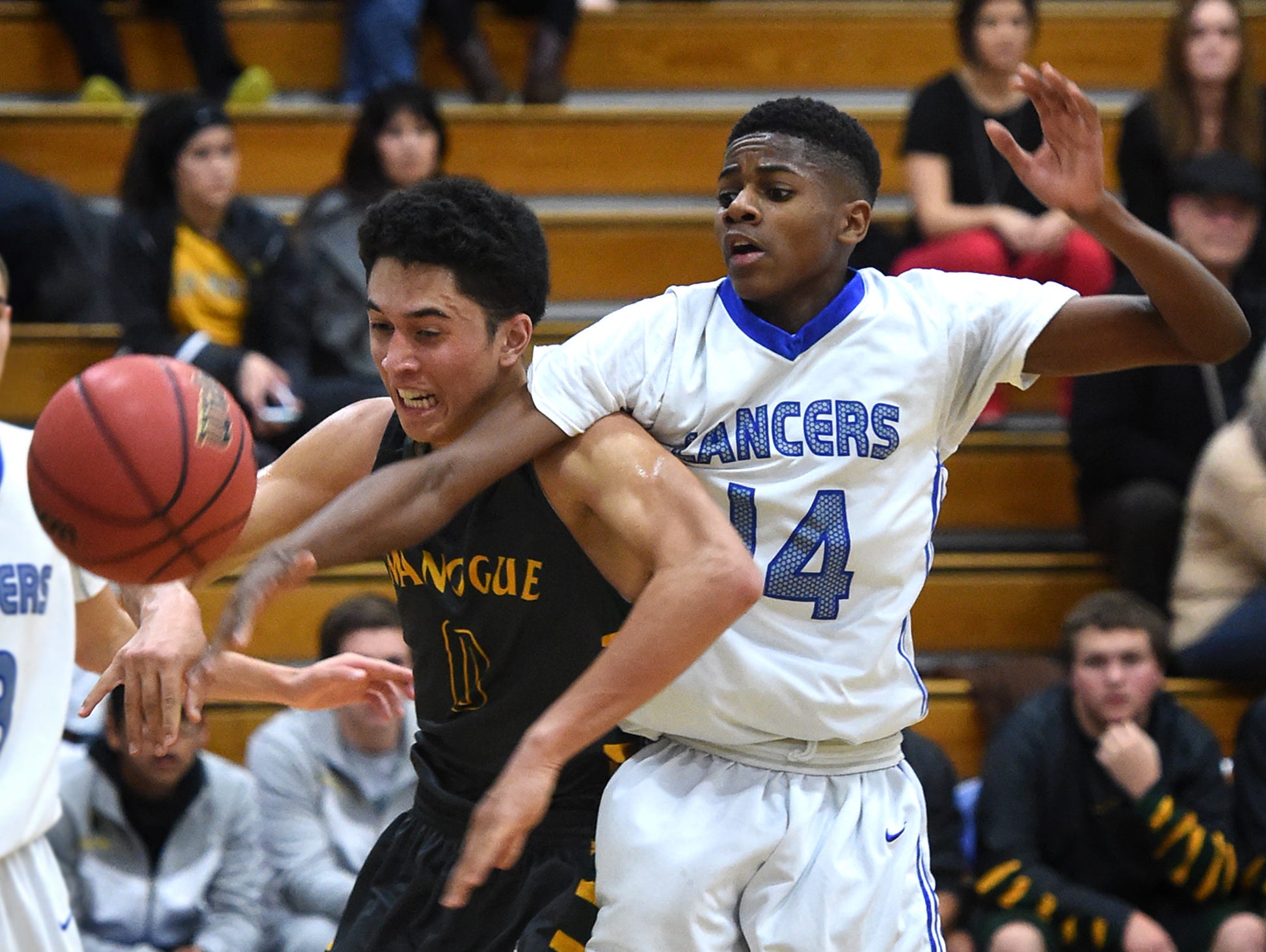 Bishop Manogue's Brevon Bansuelo and McQueen's Orlando Easter battle for the rebound in the first half of Tuesday's game at McQueen