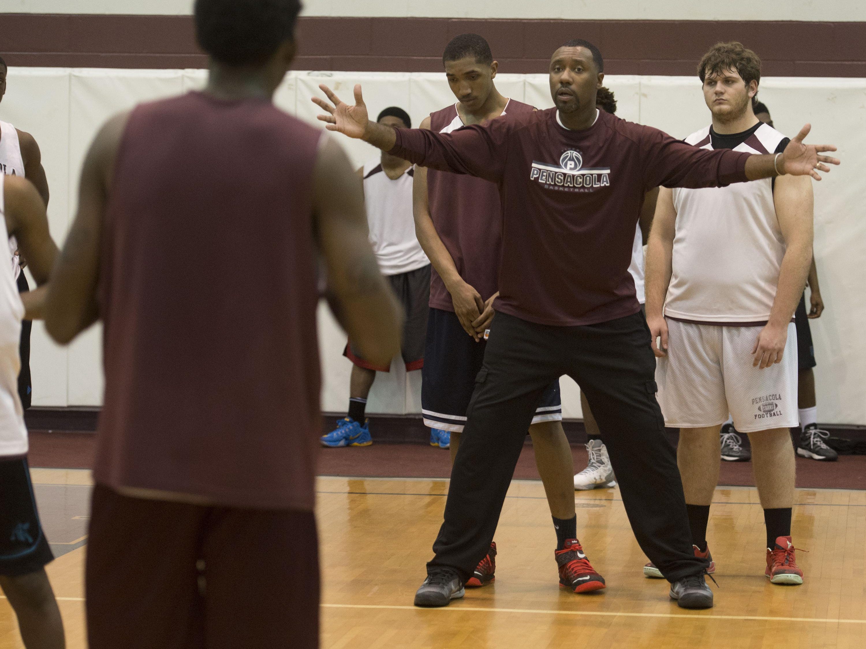 Pensacola High School Basketball coach, Terrence Harris, works to get his team ready for the Region 6A Semifinals game in Lakeland.