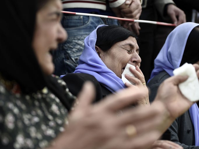 A woman cries over the loss of her daughter during a protest in support of Iraqi ethnic Yazidis in Hanover, Germany.