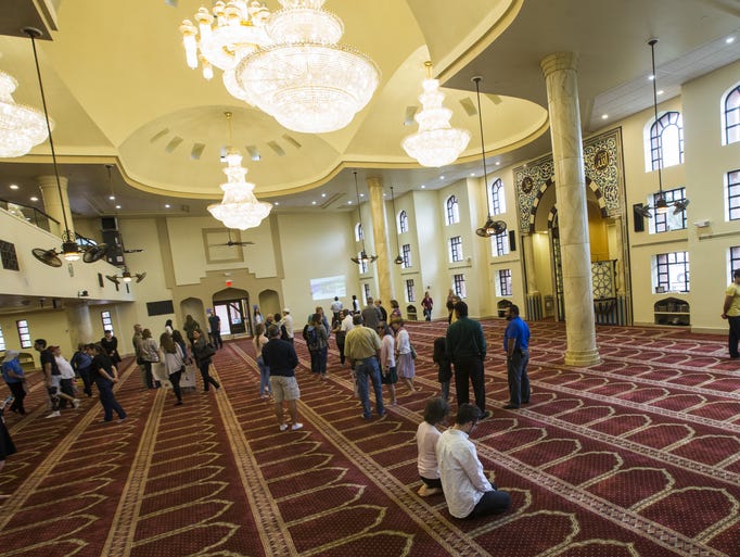 People of all faiths enter to look through the mosque