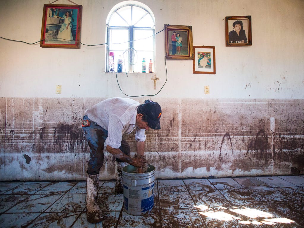 Florentino Arreola Arce, 62, washes his hands near the high water mark two days after Hurricane Patricia passed through and flooded his house in Mascota, Mexico. Residents are still cleaning up after the biggest storm ever recorded caused little dama