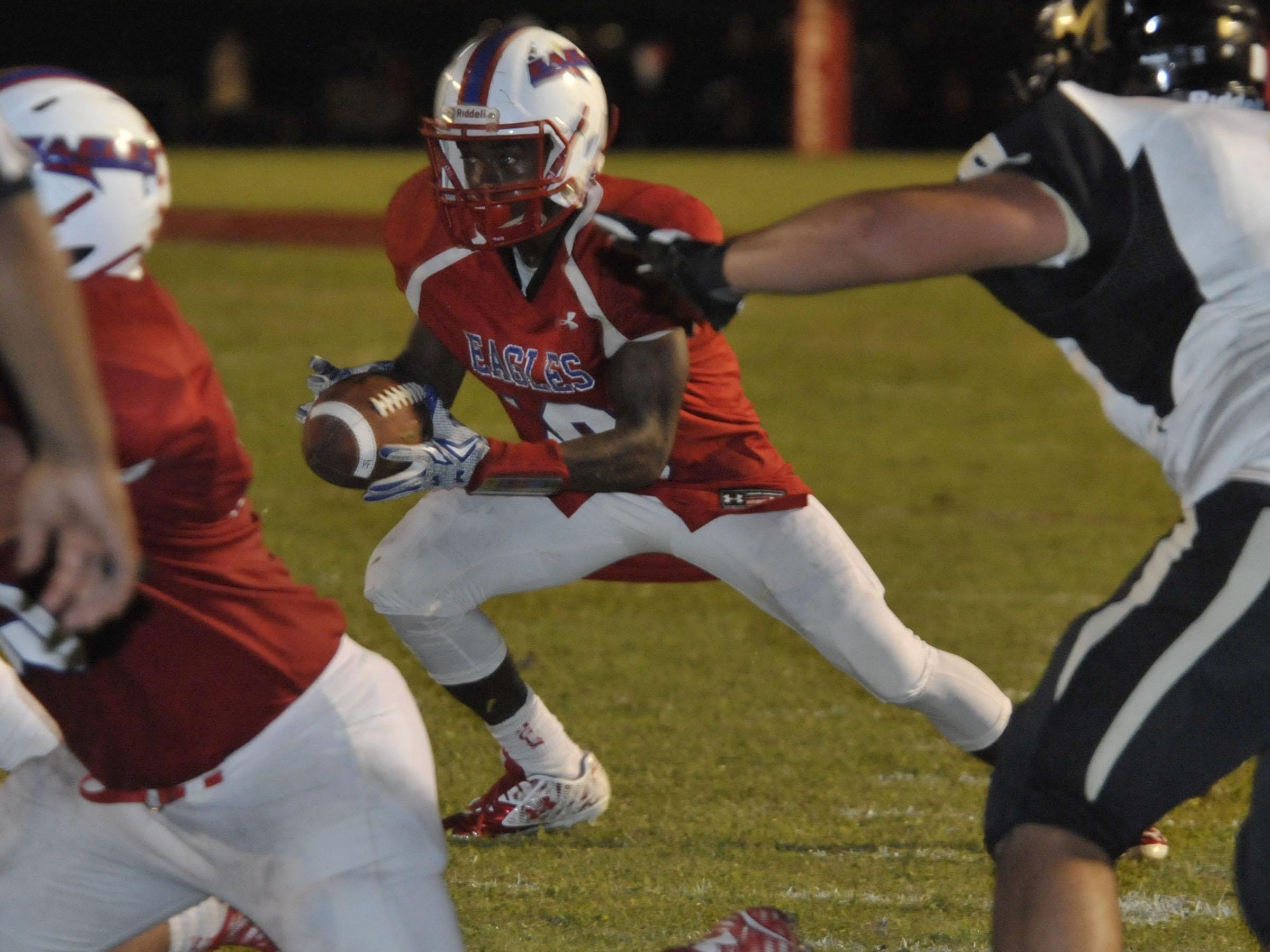 Ladarius Wiggins, No. 19 of the Pine Forest Eagles, tries to find a new way into the Milton Panthers end zone after his first path is a blocked by a Panther defender in early game action.