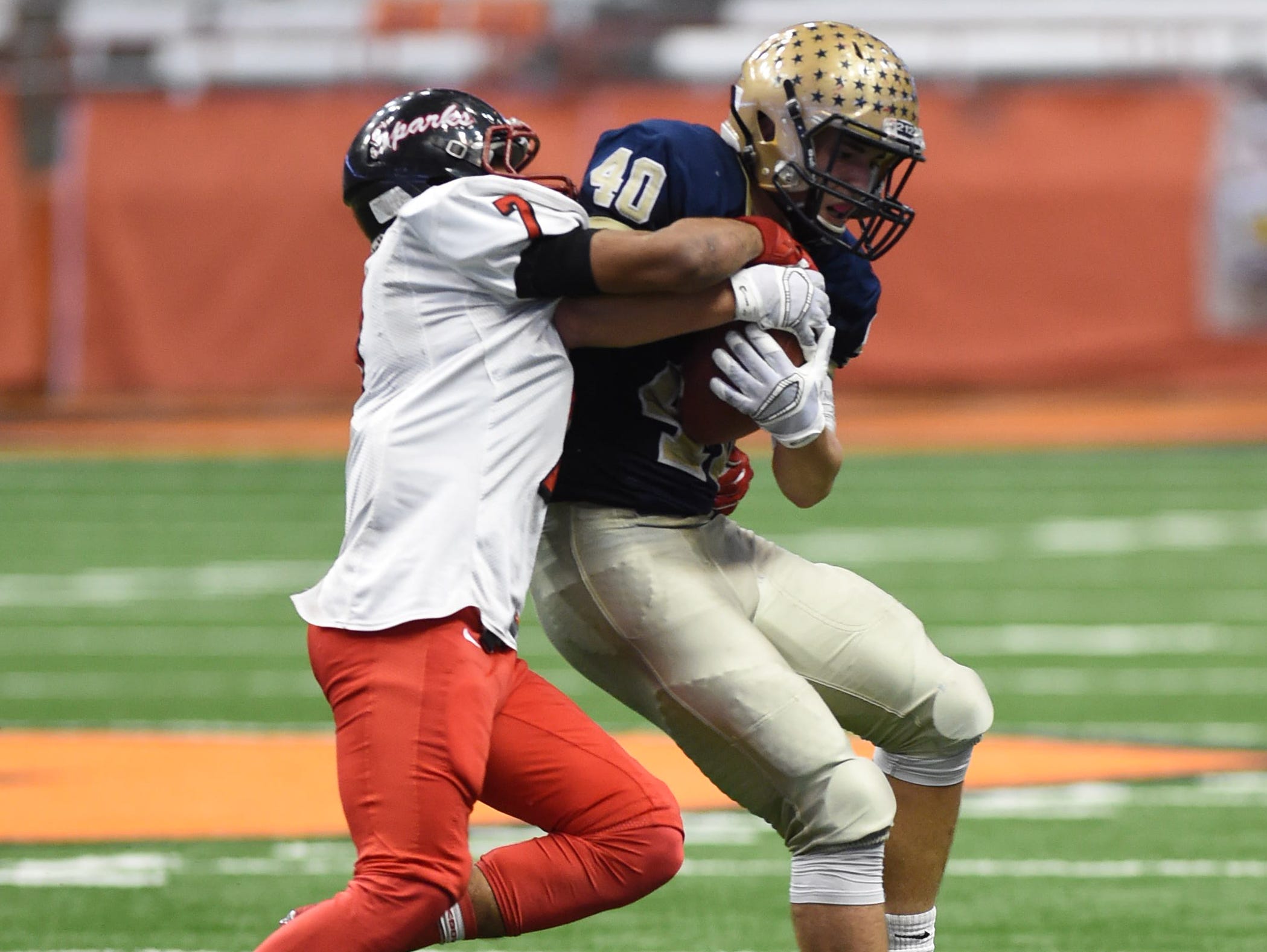 Lourdes' Billy Wagner gets tackled by South Park's Tyree Brown during the New York State Championship final in Syracuse on Friday.