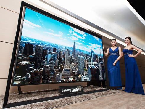 Models pose with a Samsung Electronics' 110-inch UHD TV. Samsung on Monday said a 110-inch UHD TV that has four times the resolution of standard high-definition TVs is going on sales for about $150,000 in South Korea.