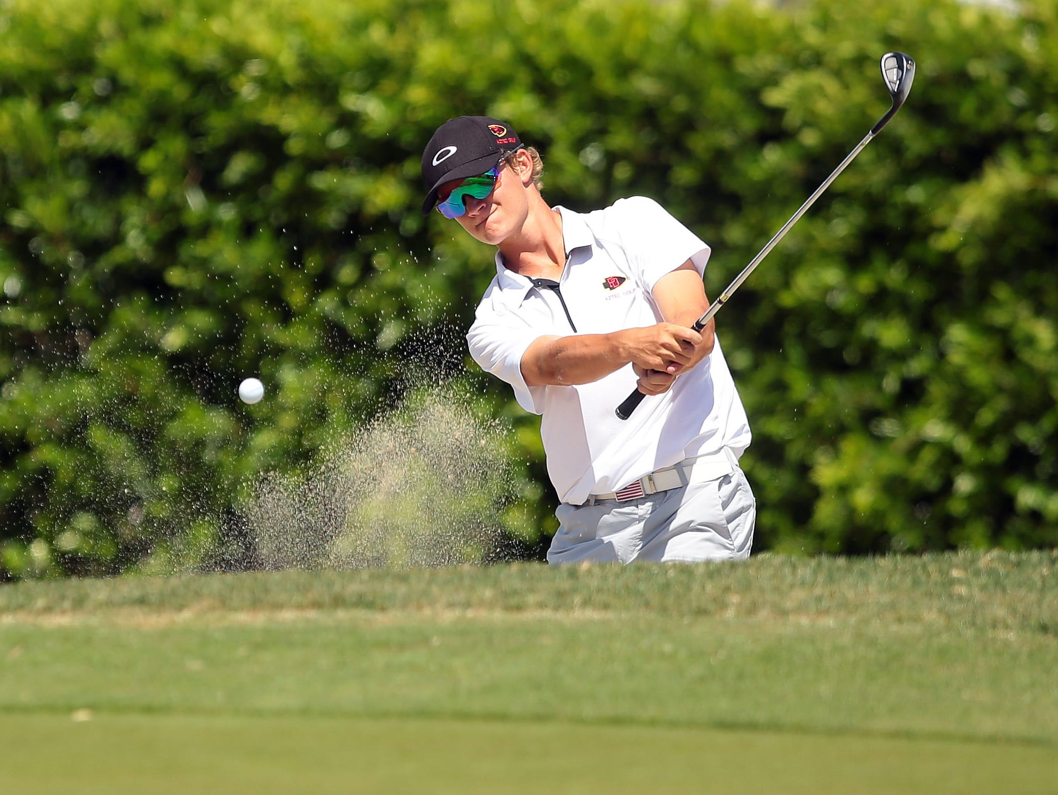 Palm Desert's Jake Vincent blasts out of a greenside bunker on the eighth hole during the Desert Valley League boys golf individual championship tournament Thursday, April 28, 2016, on the North Course at Indian Canyons Golf Resort in Palm Springs, Calif.