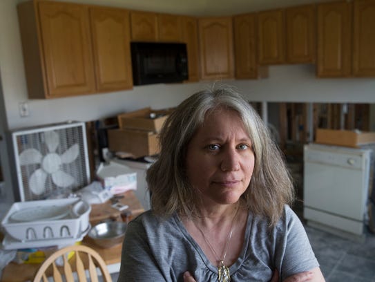 Lacey resident Laurie Fox inside her Sandy-damaged