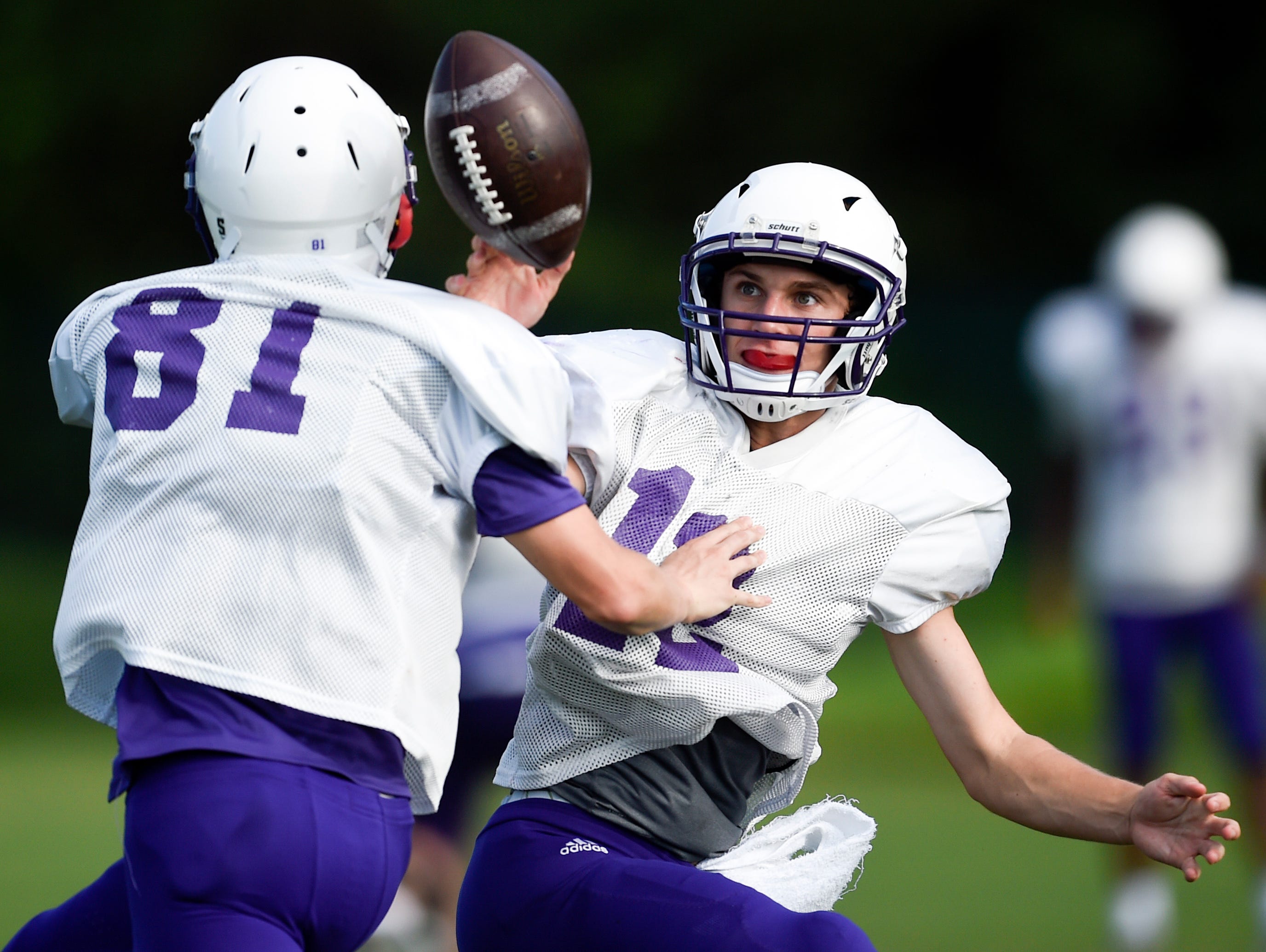 Father Ryan's Ryan Bauer (81) and Jay Shoop (12) run a drill during practice at Father Ryan High School, Monday, July 25, 2016, in Nashville, Tenn.