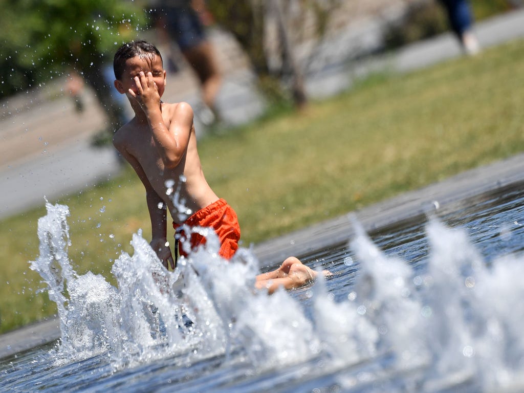 A boy cools of in a public fountain in Nantes, western France.