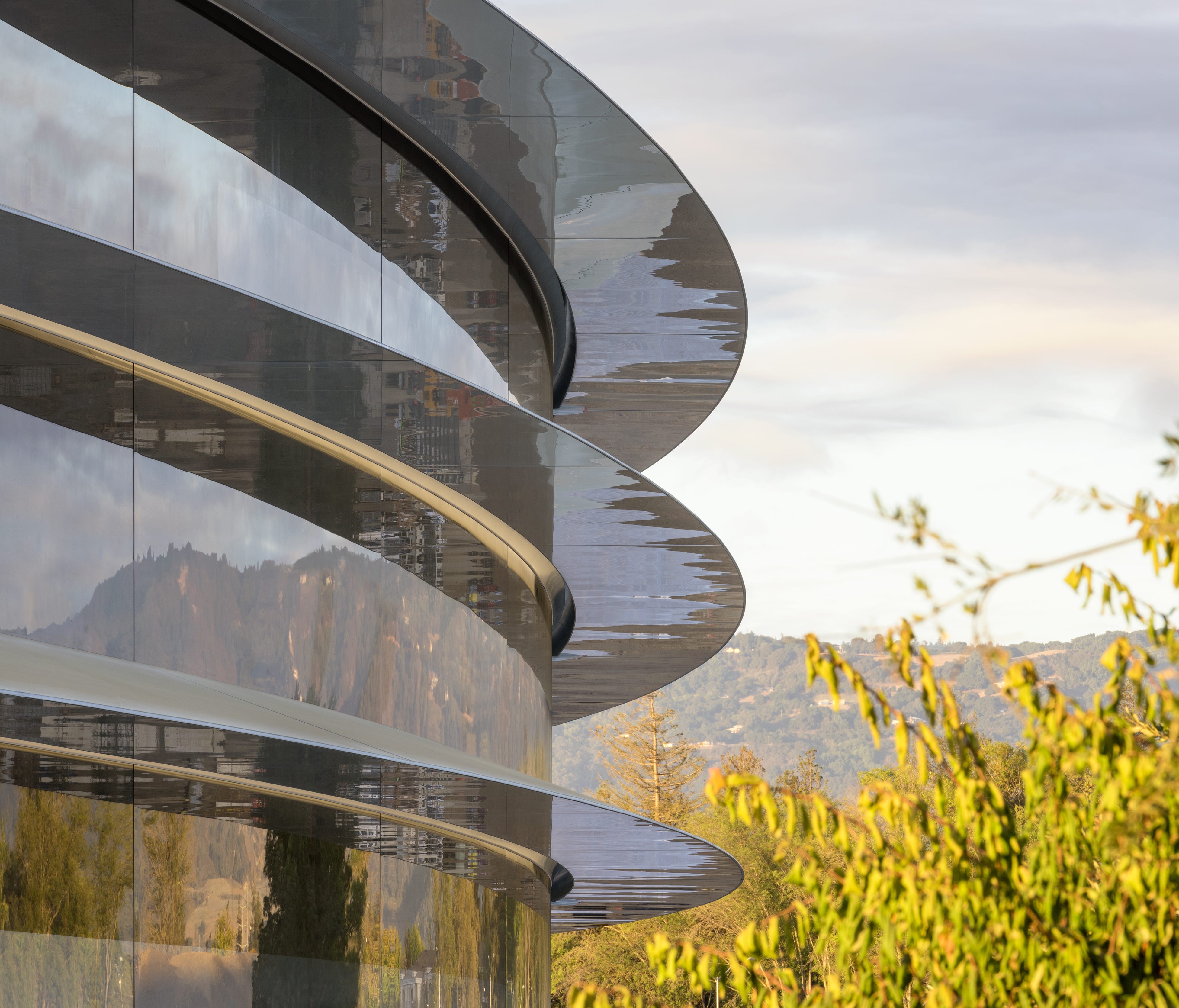 A closeup of the main ring-shaped building at Apple Park.
