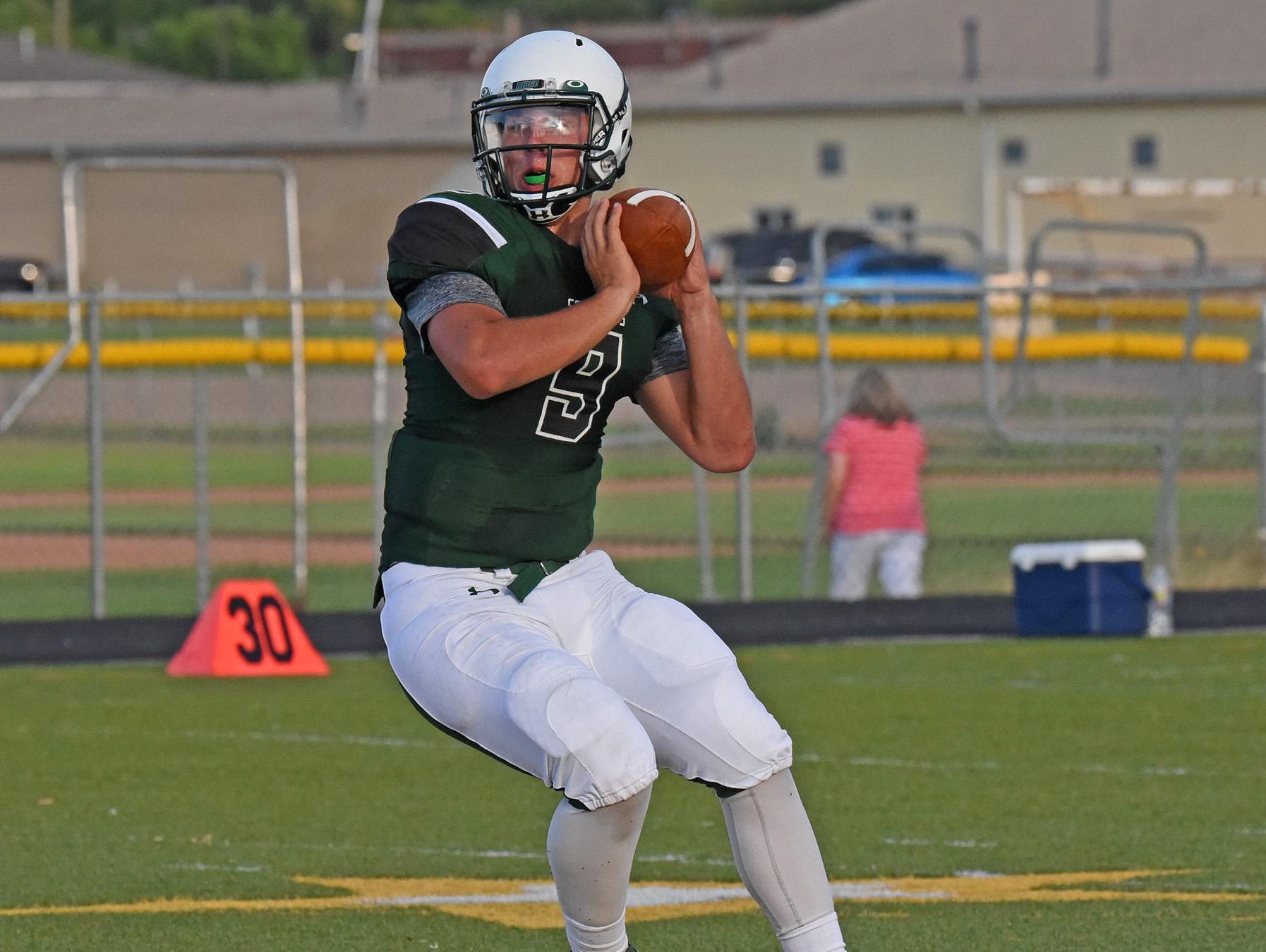 Fossil Ridge football quarterback Griffin Roberts looks for an open receiver in a scrimmage against Mountain View.