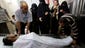 Palestinian relatives of Abed Rahman al-Zamli gather around his body at the morgue of the Najar hospital in Rafah, Gaza Strip. He was a member of the Ezz Al-Din Al Qassam brigade, the military wing of Hamas.