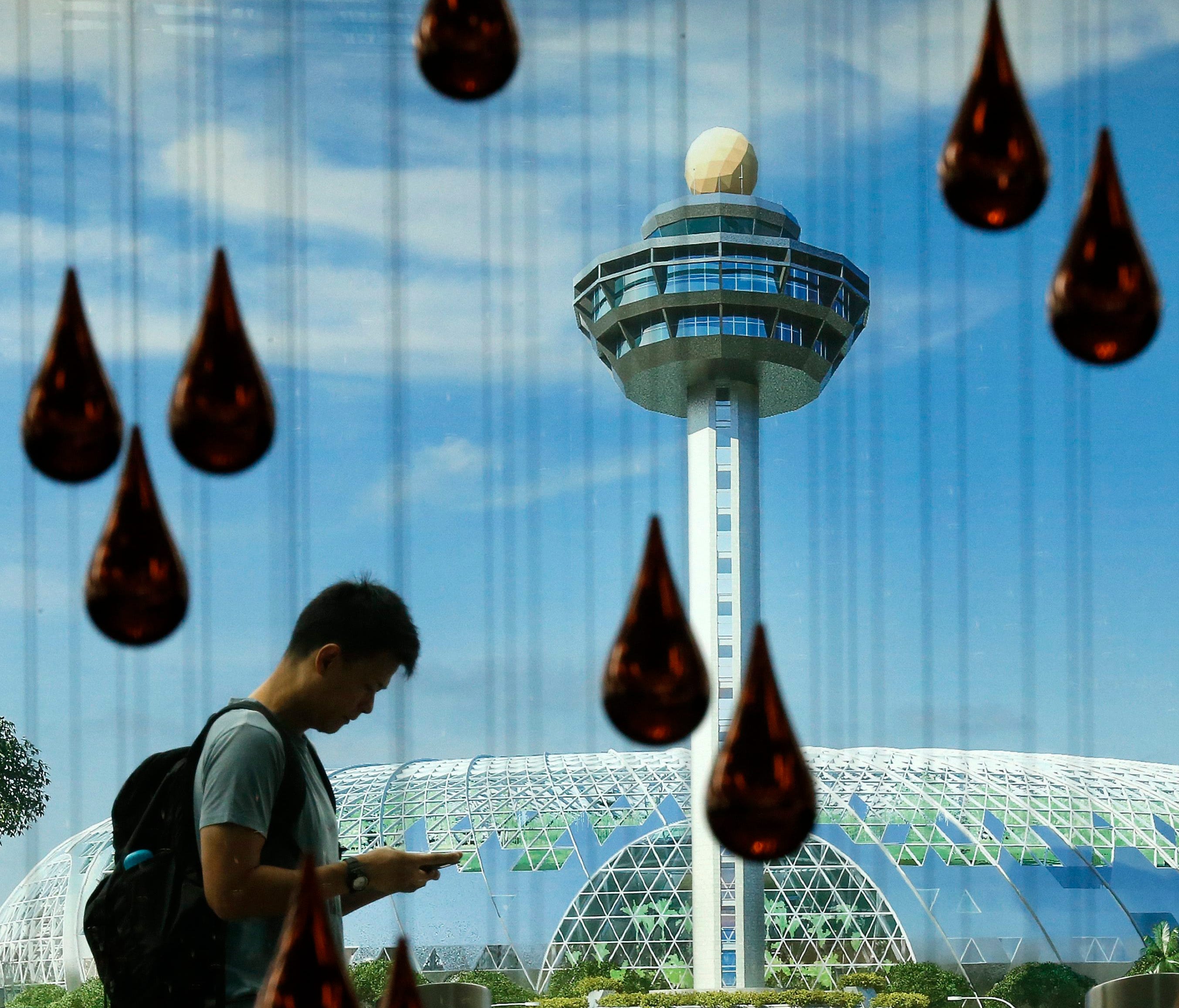 A passenger walks outside the departure area of Changi Airport in Singapore on Dec. 30, 2014.