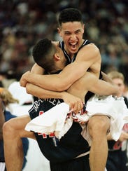 UA's A.J. Bramlett and Bennett Davison hug, after winning