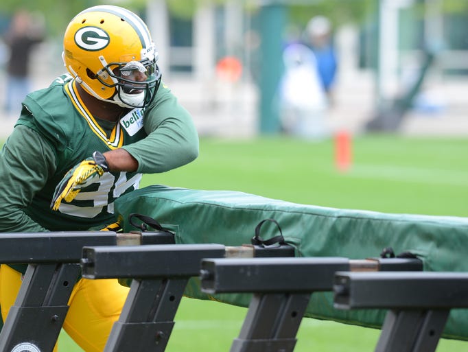 Defensive end Datone Jones (95) works on his rush technique with a blocking sled during Green Bay Packers Training Camp at Ray Nitschke Field August 12, 2014.