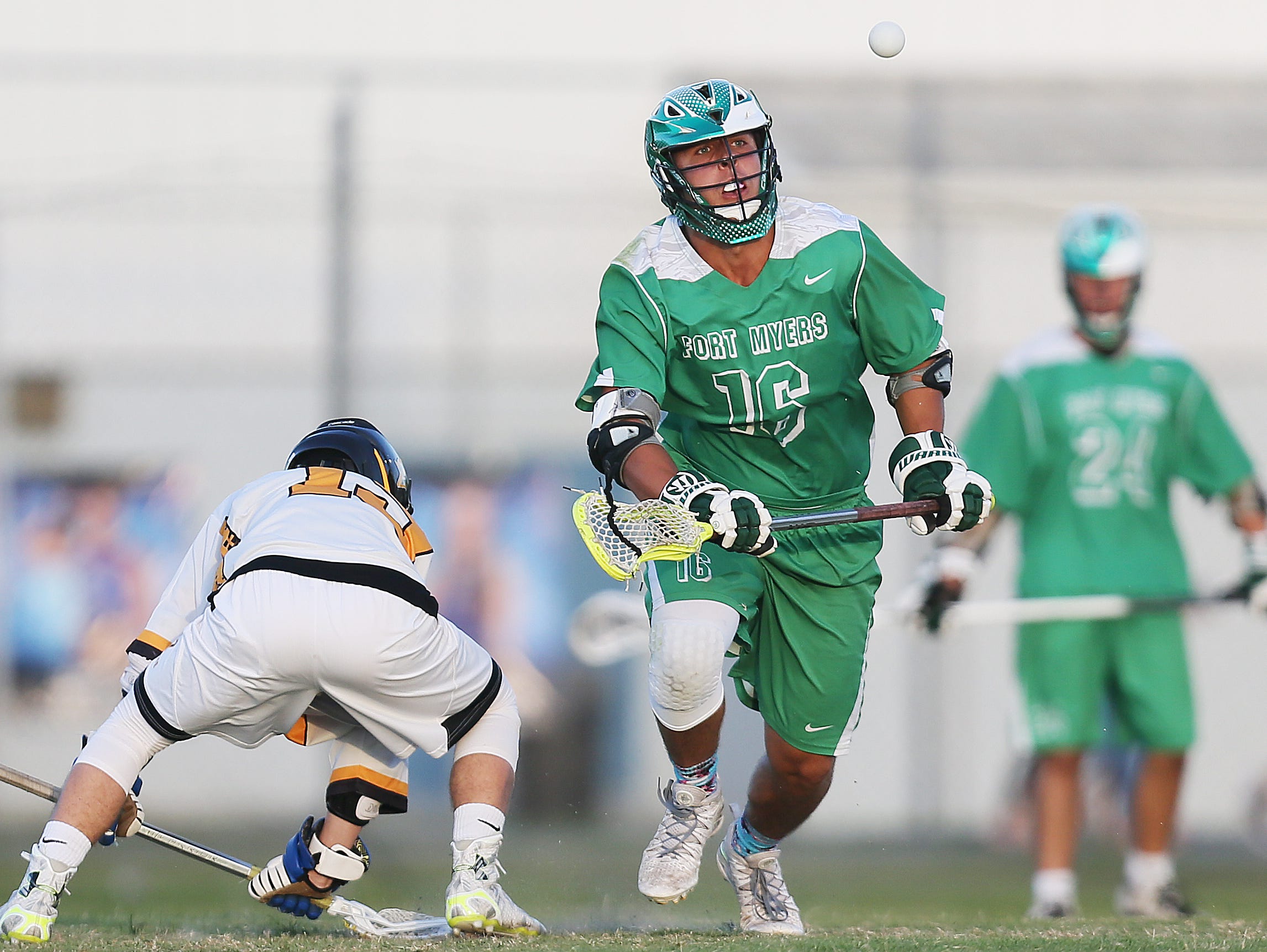 Fort Myers High School's Max Adams, center, tracks a pass against Bishop Verot during the District 18 lacrosse final Friday at the Canterbury School in Fort Myers. Bishop Verot beat Fort Myers 13-6.