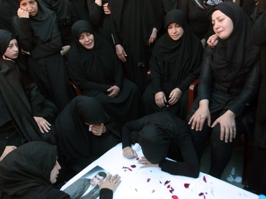 Lebanese mourners at the coffin of Adel Tormos, who