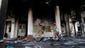 Soldiers patrol past the burned Rabaah al-Adawiya Mosque.