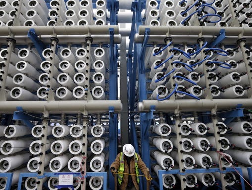 A worker is dwarfed by the cells that are part of the