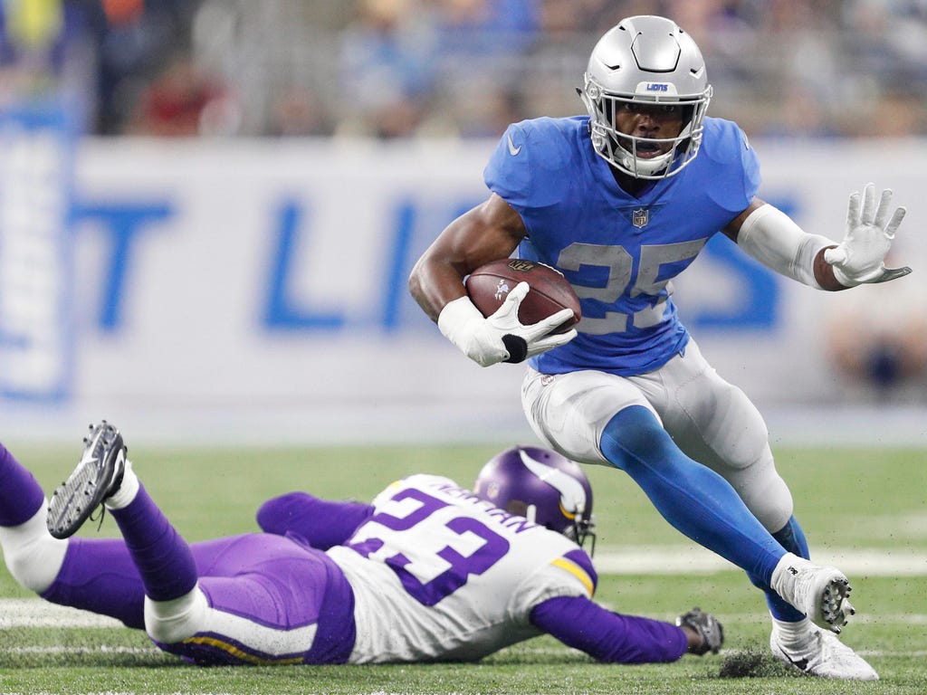 Detroit Lions running back Theo Riddick runs by Minnesota Vikings cornerback Terence Newman during the third quarter at Ford Field in Detroit.