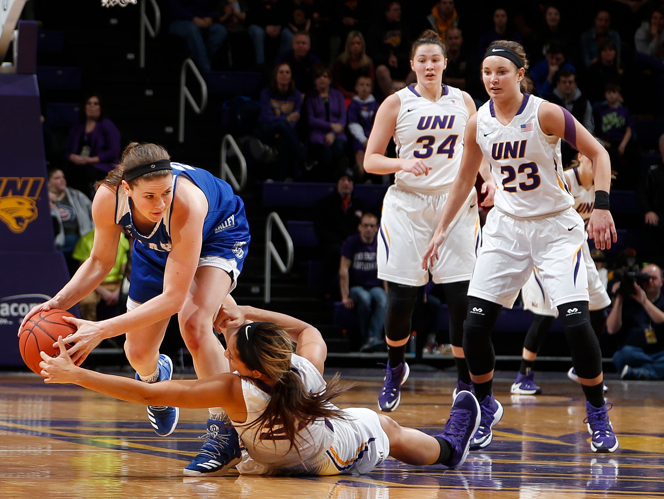 Drake's Sammie Bachrodt, left, tries to keep control of the ball as Northern Iowa's Mikaela Morgan, bottom, looks for a steal in the first half Friday, Jan. 27, 2017, in Cedar Falls, Iowa.