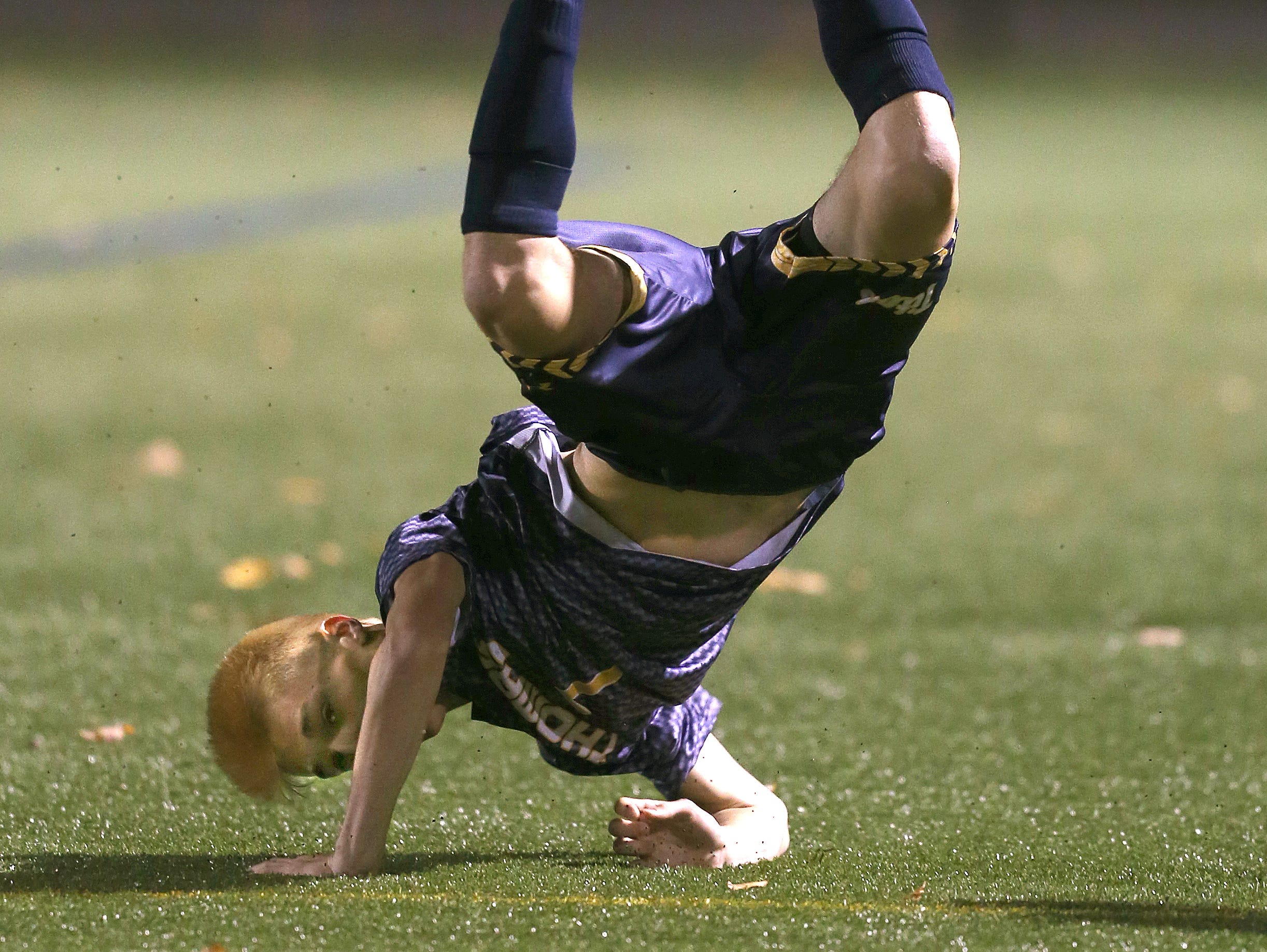 Thomas' Ryan Cullen goes airborne after a tackle against Fairport.
