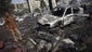 Burned vehicles and debris litter Rabaa al-Adawiya Square.