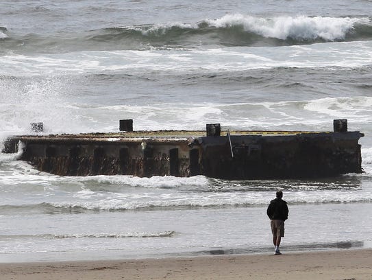 In this 2012 photo, a man looks at the tsunami dock
