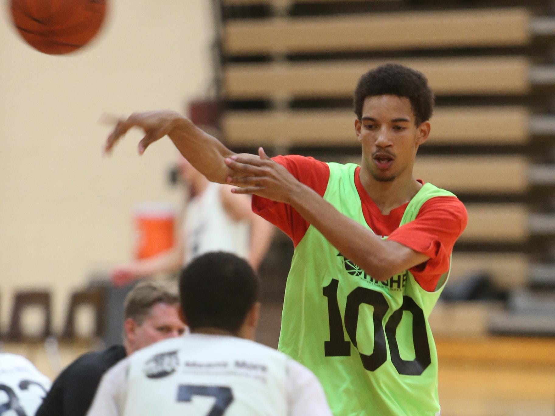 Flint Beecher senior Delon Willis competes during the Reaching Higher annual basketball camp Wednesday at Milford High School.
