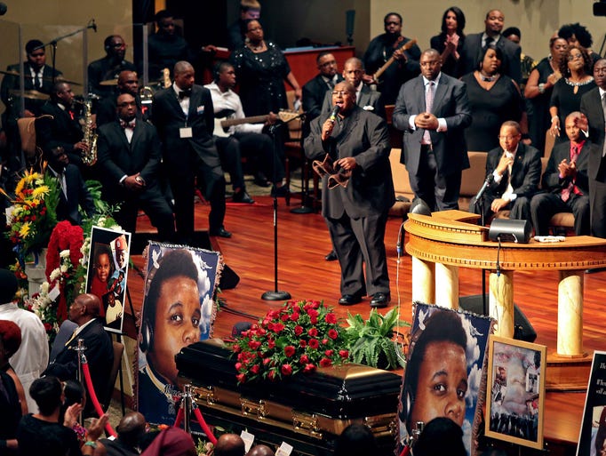 People attend the funeral of slain teenager Michael Brown on Aug. 25 at the Friendly Temple Missionary Baptist Church in St. Louis. Brown was shot and killed on Aug. 9 by a police officer in Ferguson, Mo.