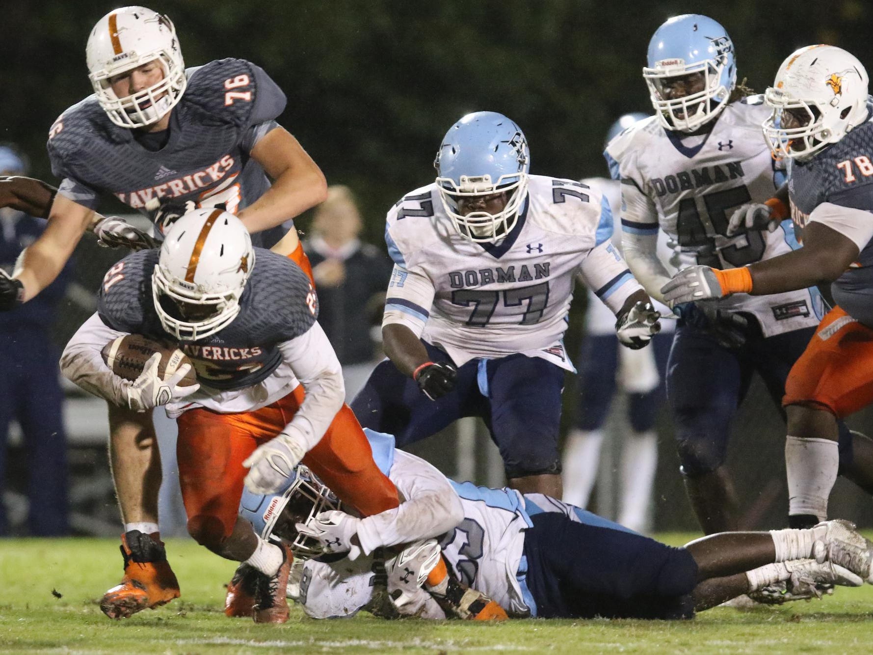 Mauldin’s Jason Labrador (21) is taken down by Dorman’s Wesley Robinson(29) during Friday’s game at Mauldin.