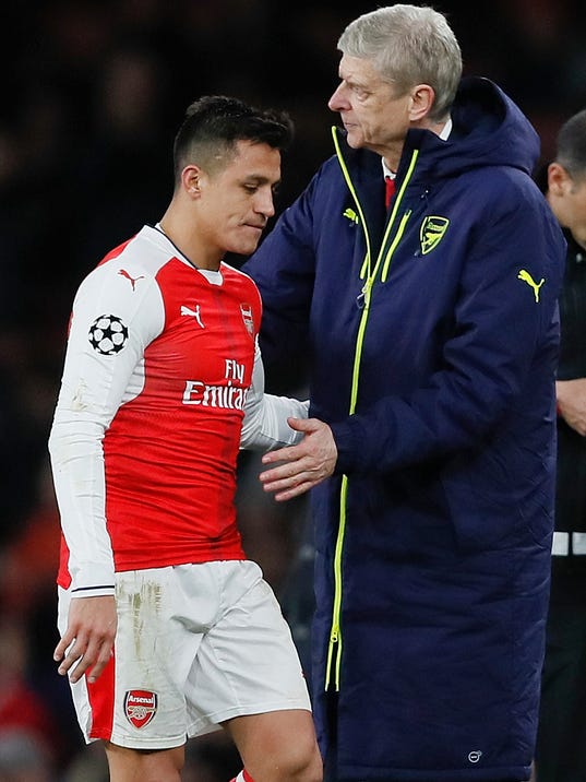 Arsenal's Alexis Sanchez, left hugs with Arsenal manager Arsene Wenger during the Champions League round of 16 second leg soccer match between Arsenal and Bayern Munich at the Emirates Stadimum in London, Tuesday, March 7, 2017. (AP Photo/Kirsty Wigglesworth)