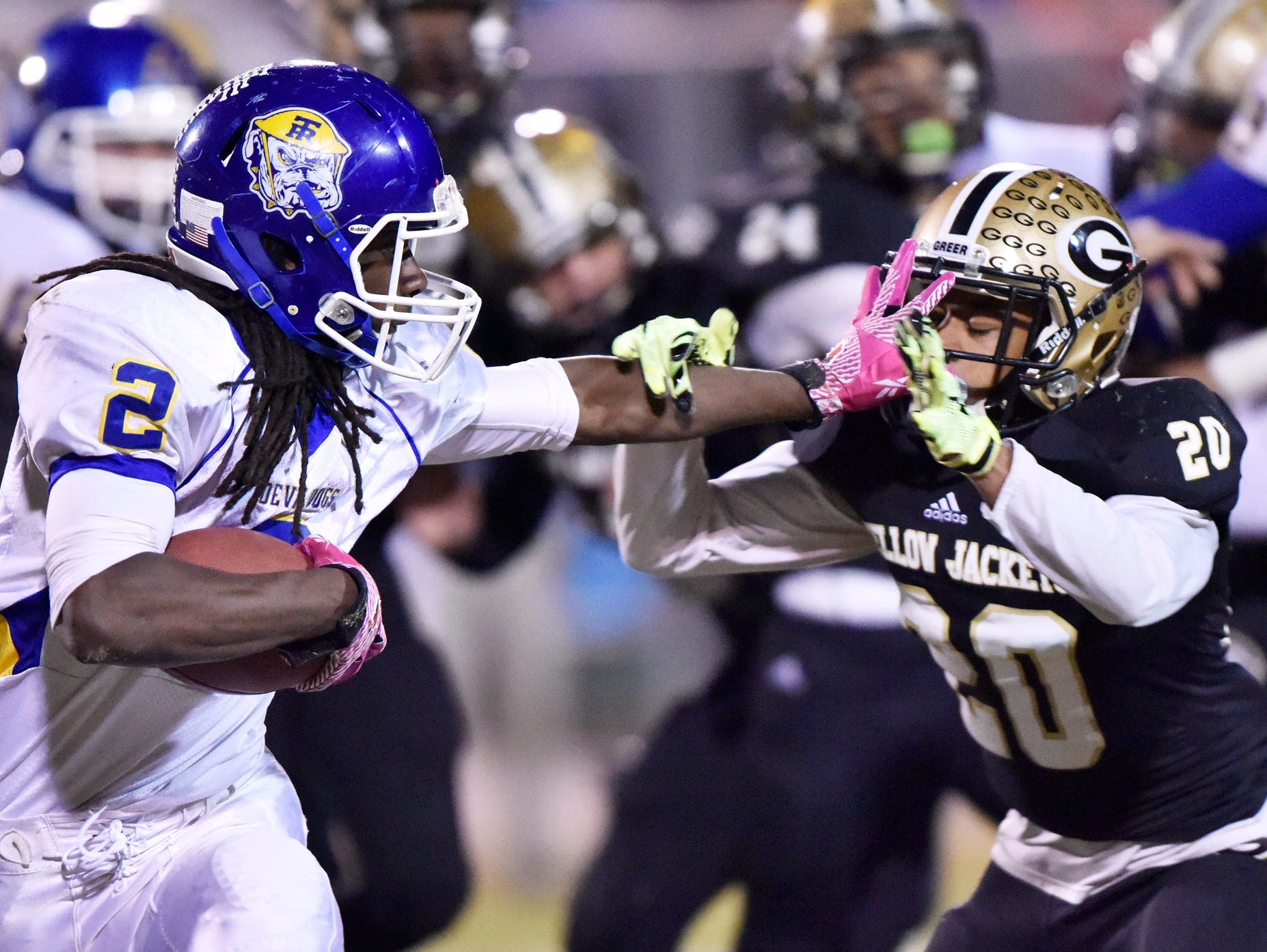 Travelers Rest's Xaiver Terry (2) fends off Greer's D.J. Sitton (20).