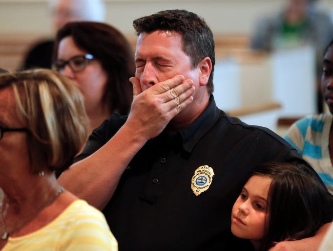 Chuck Hartung holds his daughter Haley, 8, during a