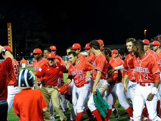 The Cajuns celebrate a home run by Brenn Conrad (13)