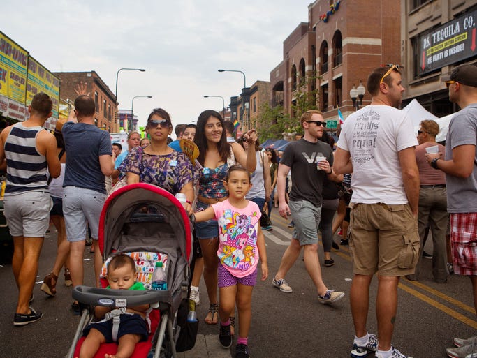 Patty Corono of Hammond, Ind., walks with her children including Jennifer Castaneda, at right, Natalie Ornelas, 6, and Alexander Ornelas, 7 months, during the Northalsted Market Days festivities in Chicago's Boystown, the nation's first municipally recognized gay village.