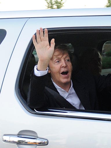 Paul McCartney waves to fans as he enters Bridgestone