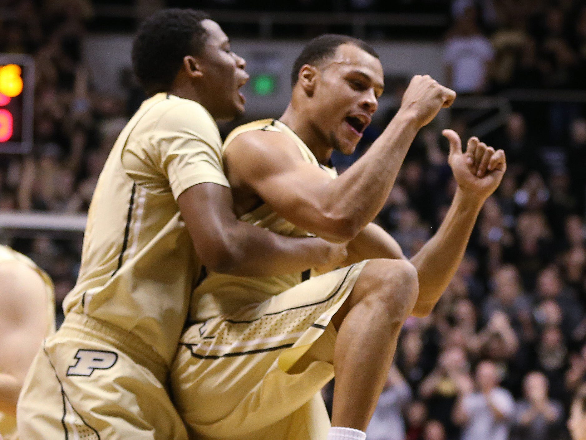 Purdue Boilermakers forward Basil Smotherman and teammate Bryson Scott celebrate Purdue's double digit lead over Indiana in the first half. Purdue hosted Indiana at Mackey Arena Wednesday, January 28, 2015.