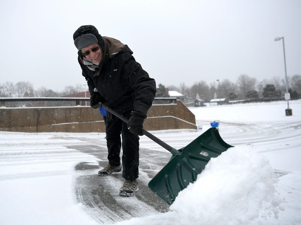 Paul Bianchi clears the driveway at the Brentwood YMCA on Jan. 16, 2018 in Brentwood, Tenn.  A mixture of sleet and snow started falling just before midnight in the greater Nashville area and 2-3 inches were expected to hit the ground by late Tuesday