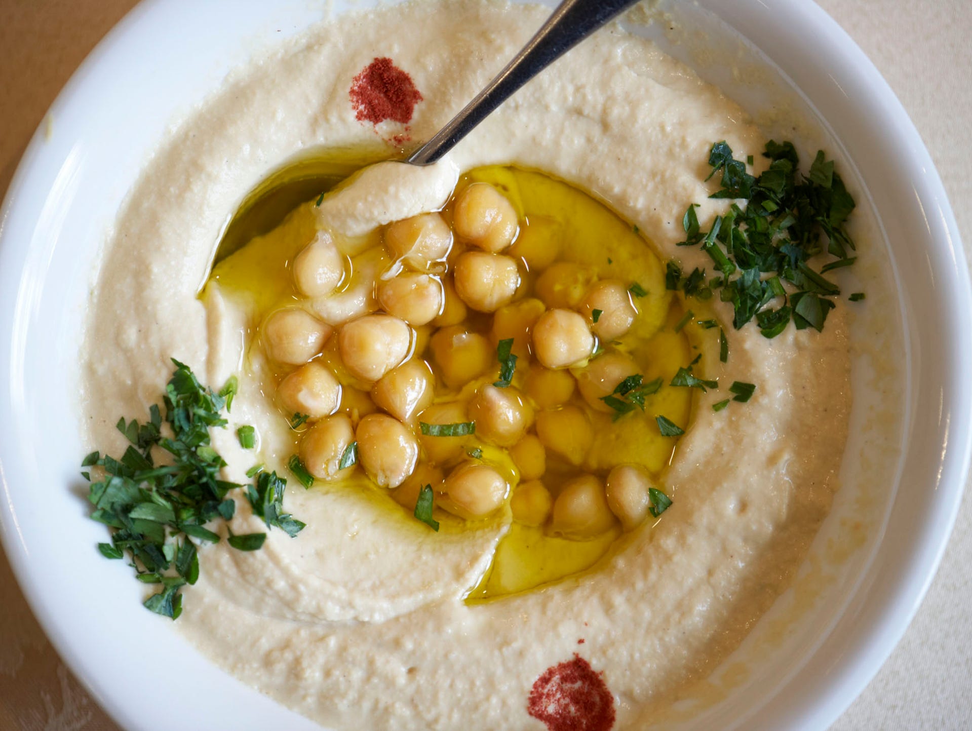 Syria: The regional cuisine blends Mediterranean and Middle Eastern flavors, and includes many varieties of kebab Halabi, or spiced kebab, traditional mezze dishes such as hummus and baba ghanoush, and za'atar, a dried herb and spice mixture, often eaten by dipping it with bread in olive oil.