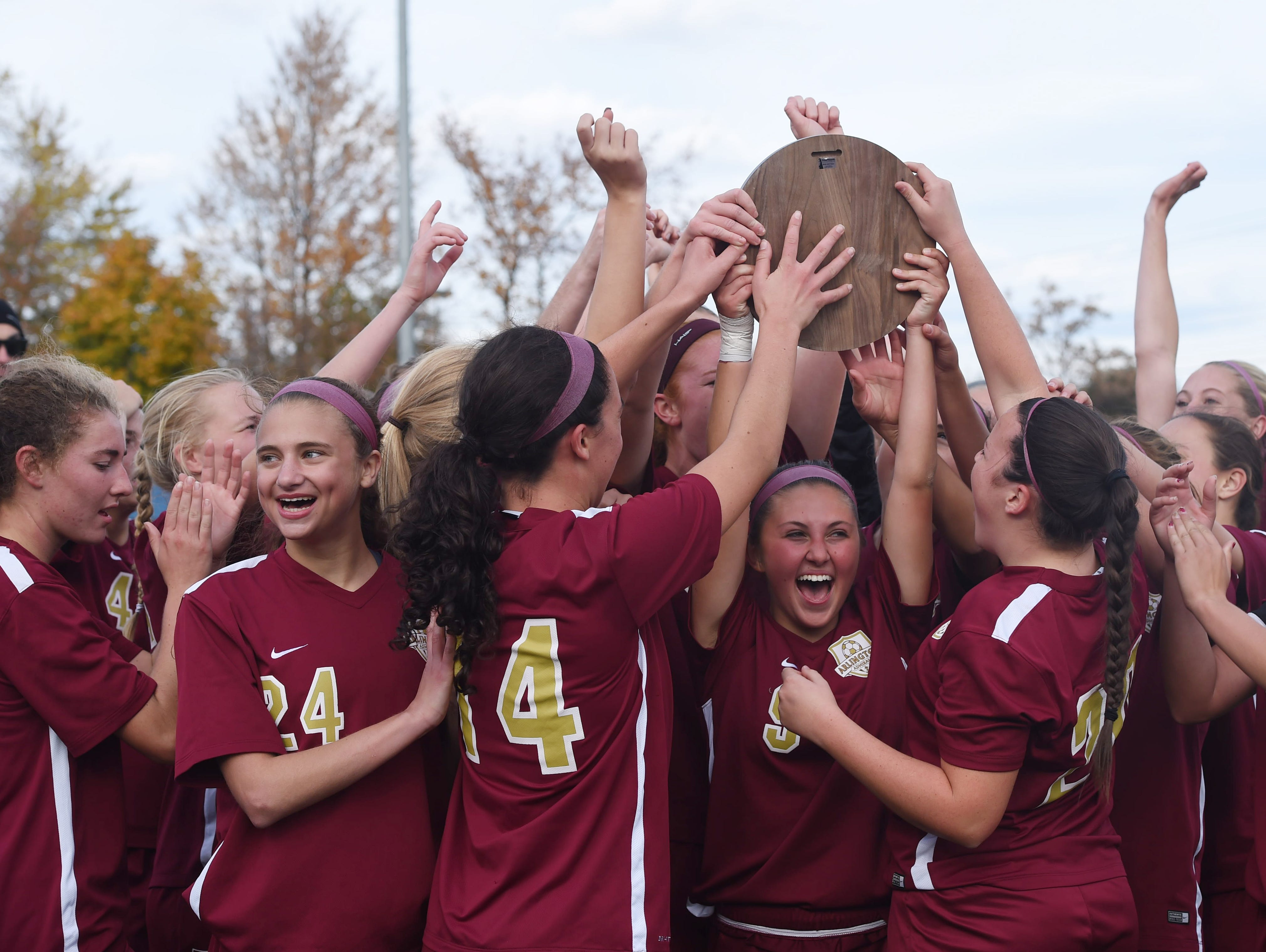 The Arlington girls soccer team celebrates after winning the Class AA regional final against Monroe-Woodbury.