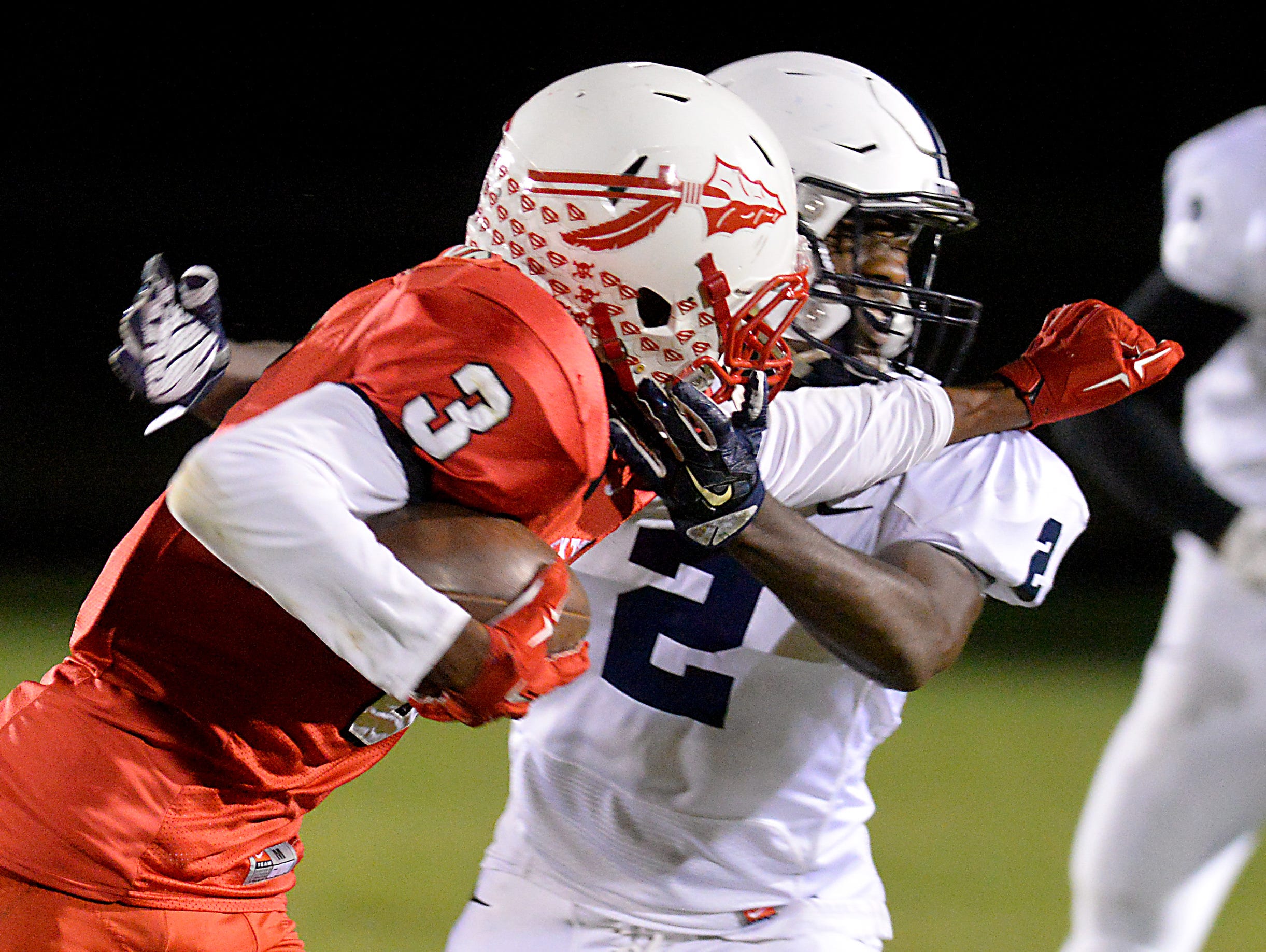 Sexton receiver Devin Taylor stiff arms East Lansing defensive back Kentre Patterson for a first down after a catch at Sexton Friday 10/9/2015.