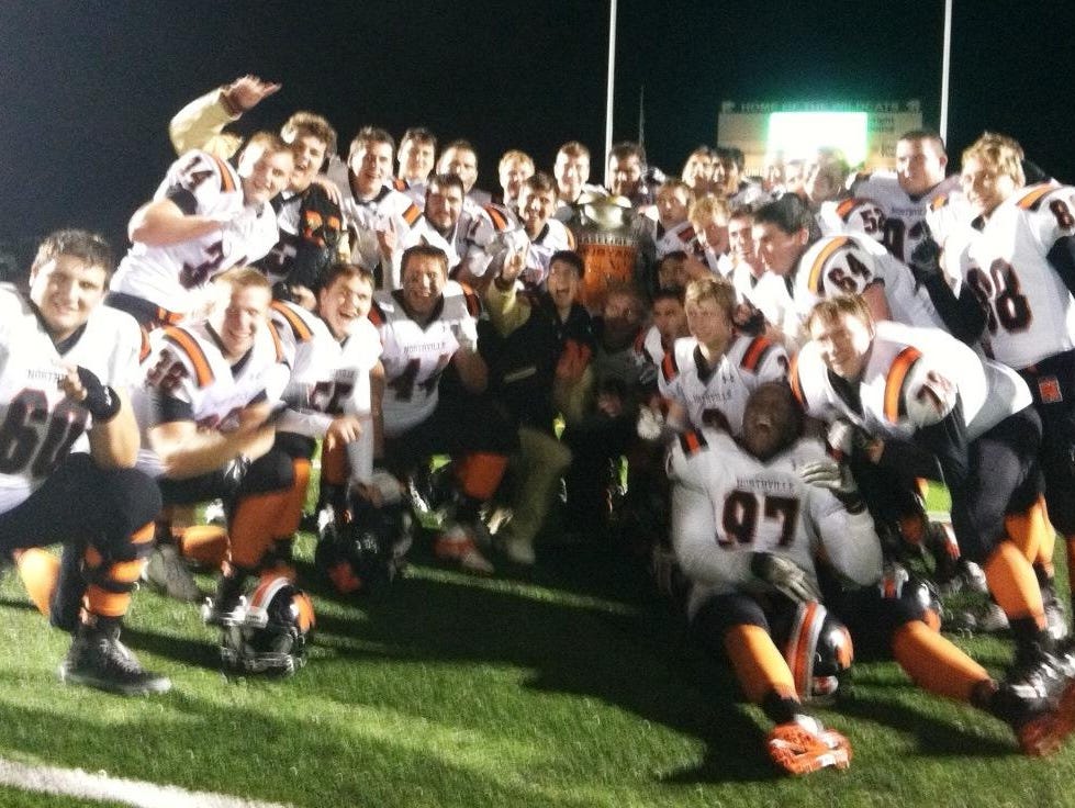 Northville players celebrate after earning a 35-25 victory over host Novi.