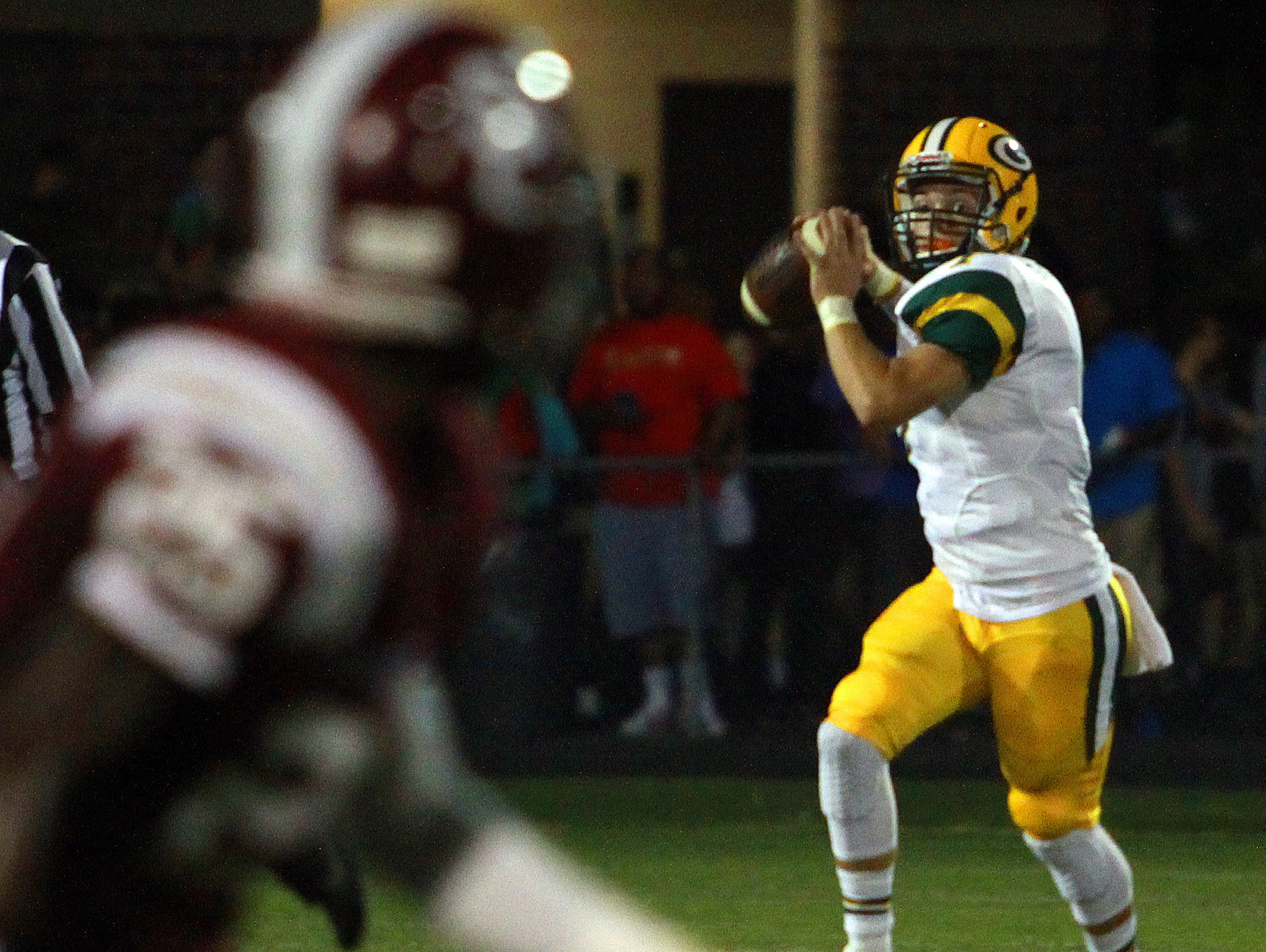 Gallatin quarterback Cpllin Minor looks downfield for receiver Matthew Knight as Station Camp's Shawn McKinley defends during Friday's game.