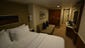 Mini Suites have a king-size bed that can be separated to form two smaller beds, a large closet, a sofa bed with additional storage and a built-in desk area.