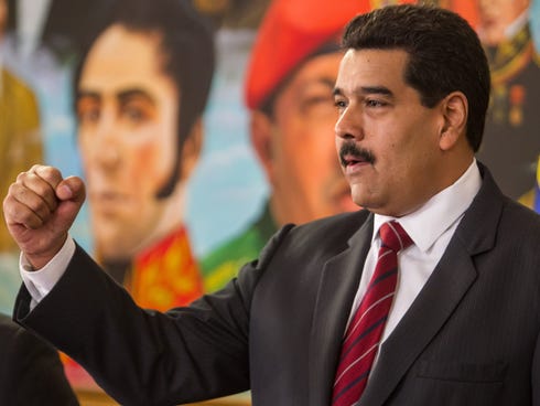 Venezuelan President Nicolas Maduro clenches his fist as he participates in a work meeting with the  Venezuelan National Assembly at the Miraflores Palace in Caracas, Venezuela.