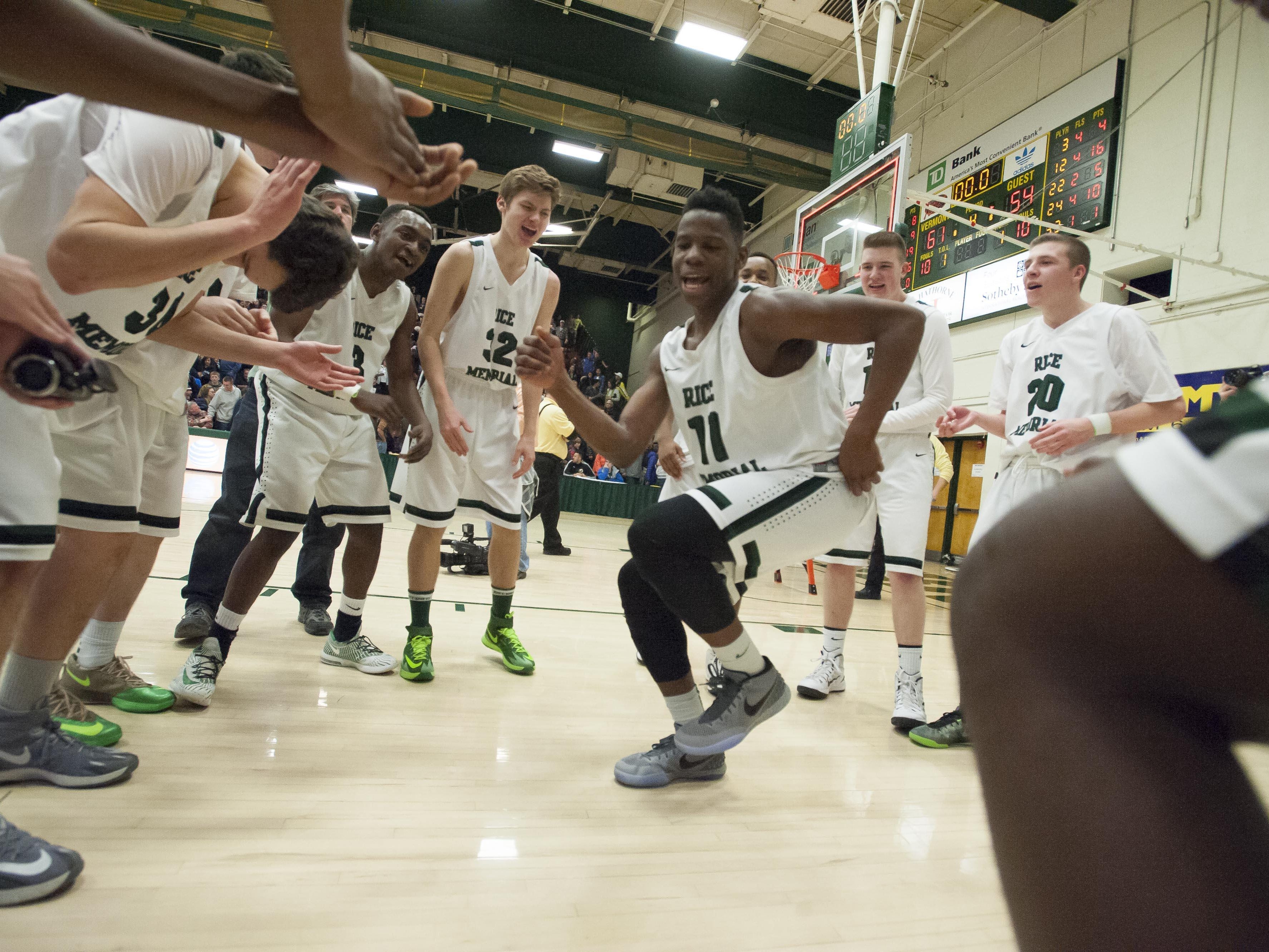 Rice's Ben Shungu dances with his teammates after defeating Burlington during the D-1 boys state basketball championship at Patrick Gymnasium in Burlington on Saturday, March 7, 2015.